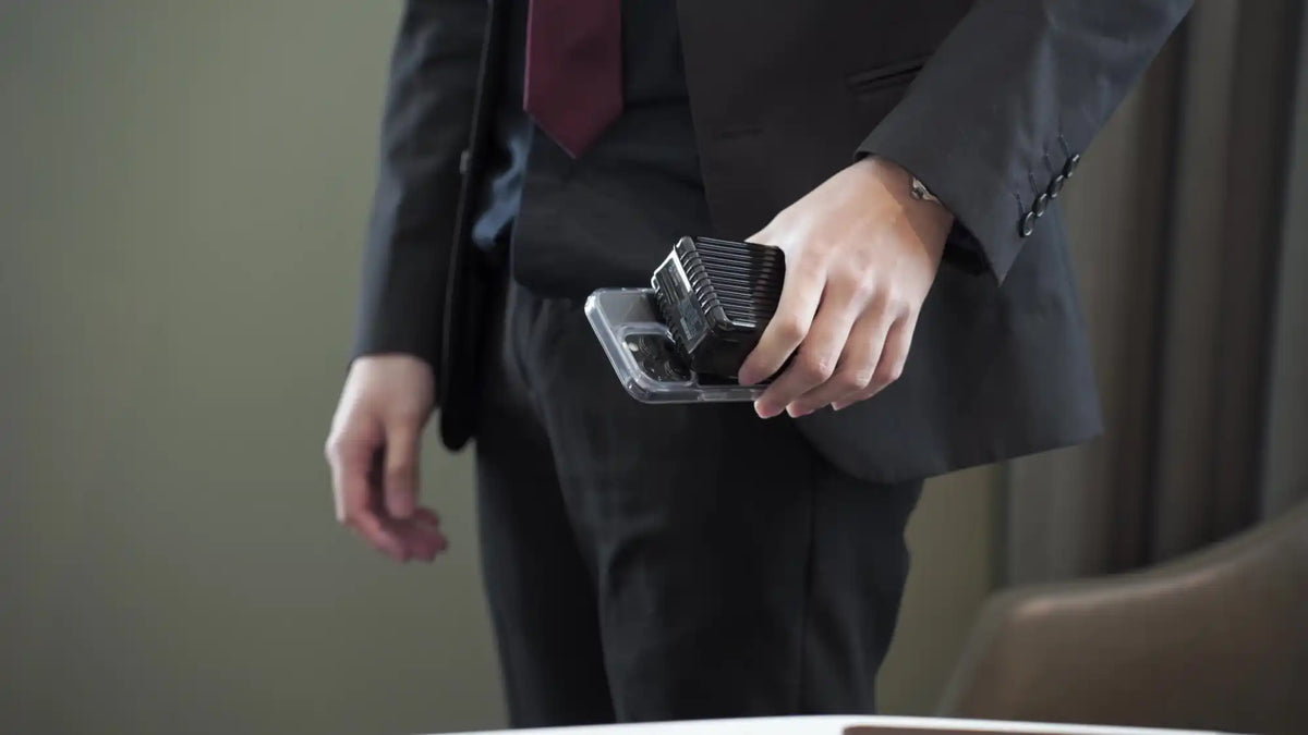 Black cube atop a smartphone.