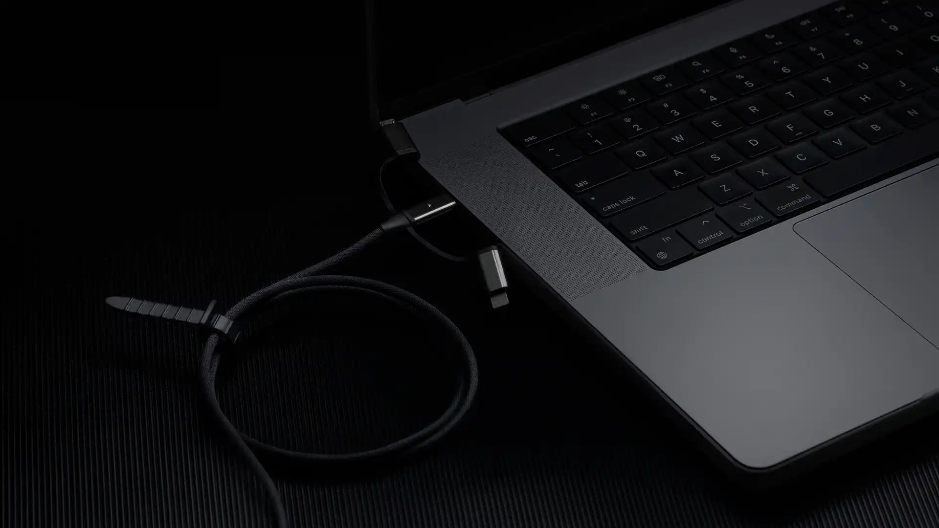 Gray laptop with charging cable.
