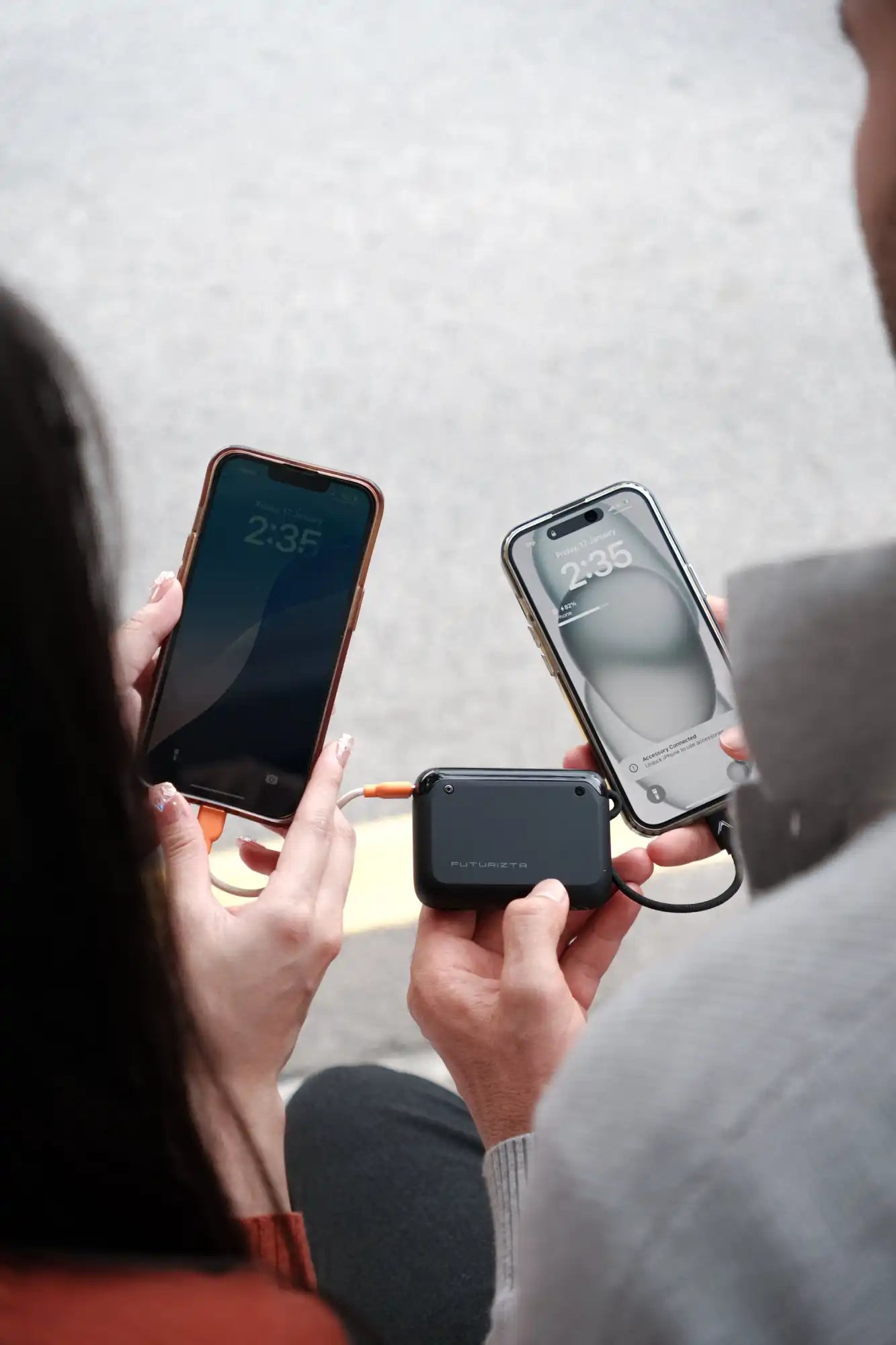 Portable power bank charging two phones.