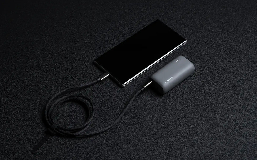 Smartphone connected to a portable charger.
