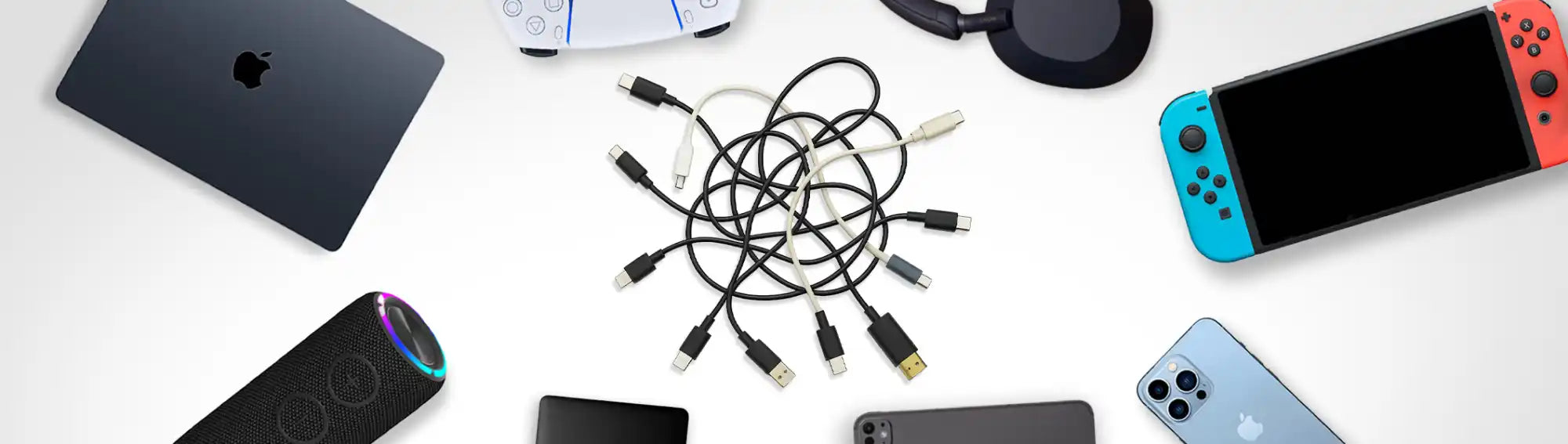 A tangled pile of various USB cables, including USB-A, USB-C, and micro-USB.