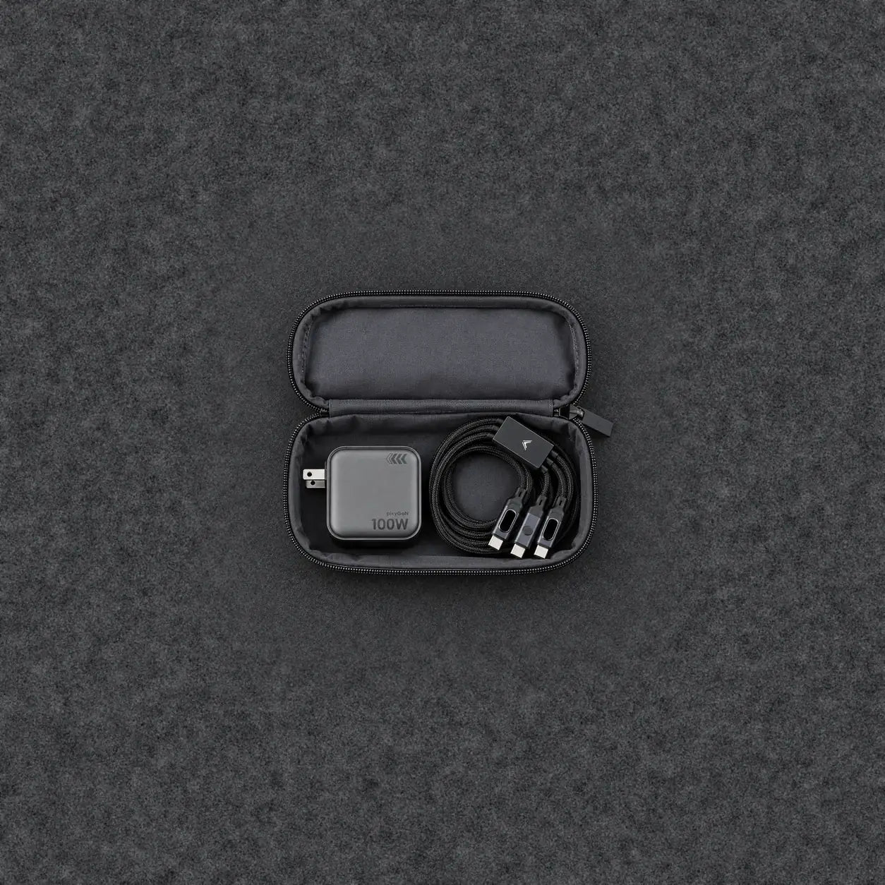 A small tech pouch holding only the Pixy 100W GaN charger and the Hydra LED cable