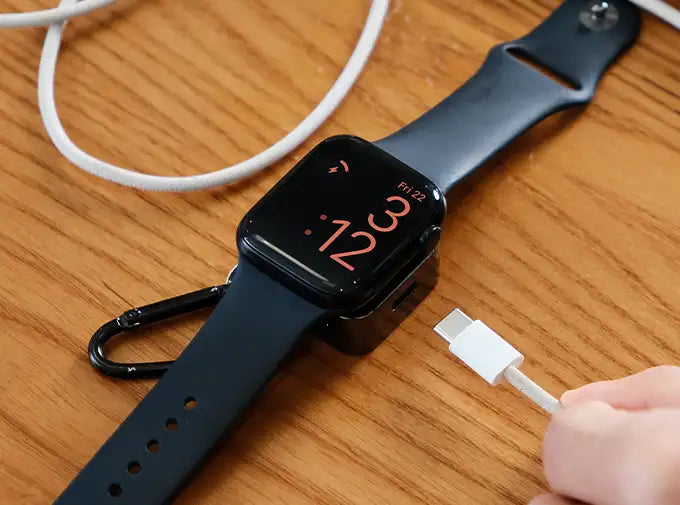 Apple watch with black face and blue strap, featuring a sleek design.