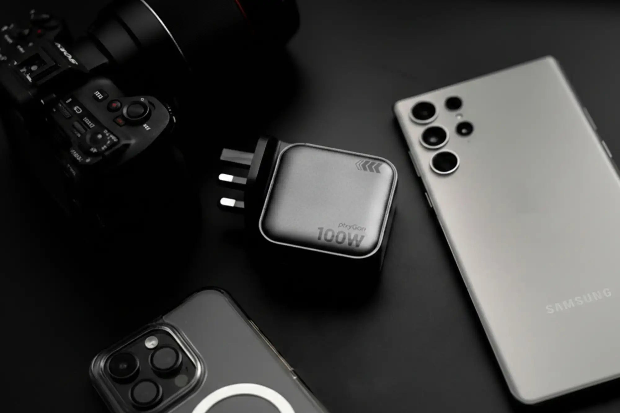 Black 100w power adapter with sleek metallic finish and minimalist design