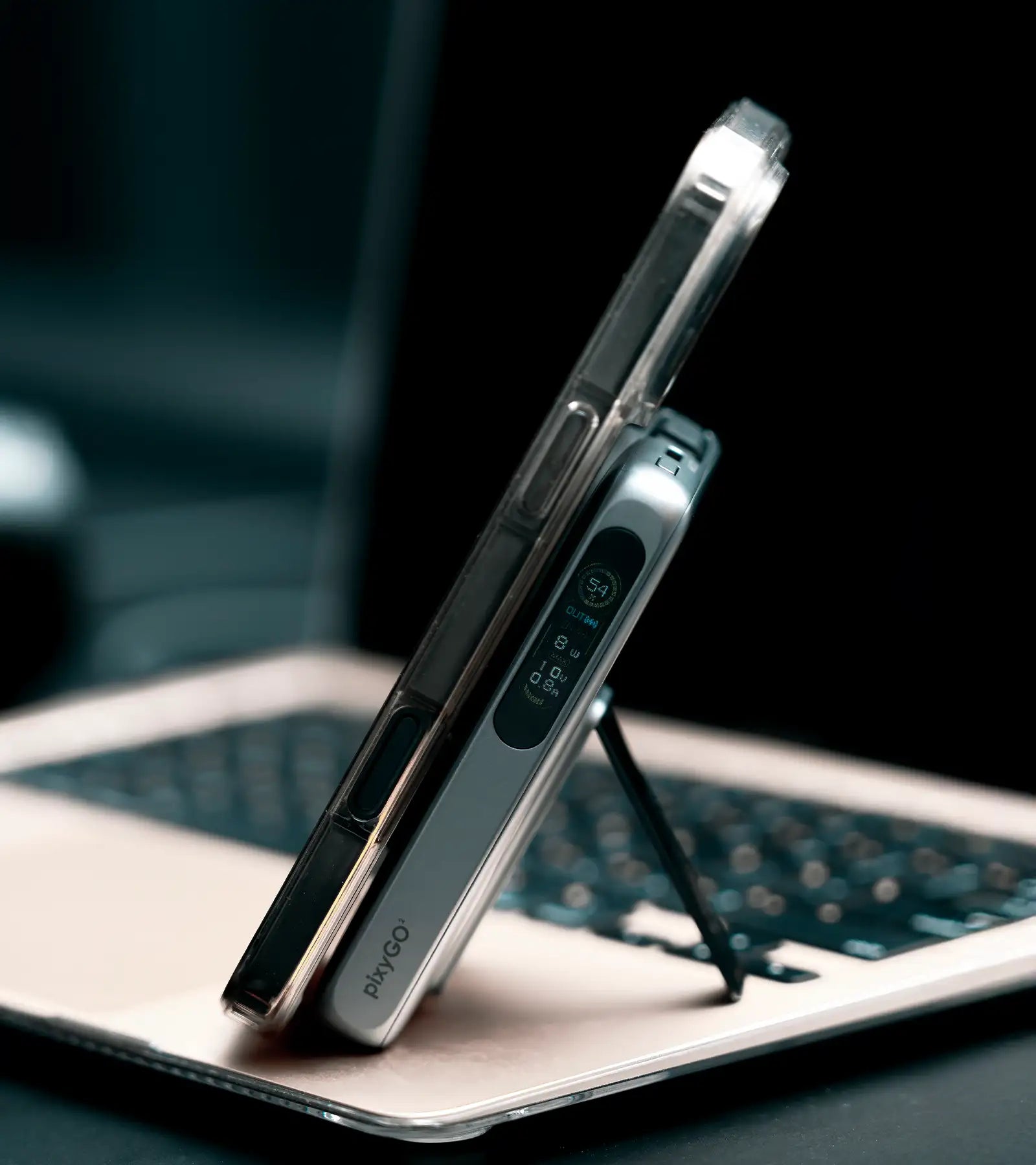 A sleek silver and transparent phone case with a built-in stand, branded ’pivygo,’ supporting a smartphone in an upright position.